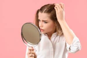 Worried,Young,Woman,With,Hair,Loss,Problem,And,Mirror,On